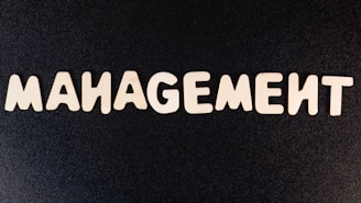 the word management written in white letters on a black background