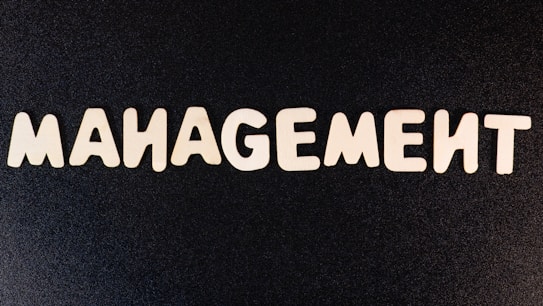 the word management written in white letters on a black background