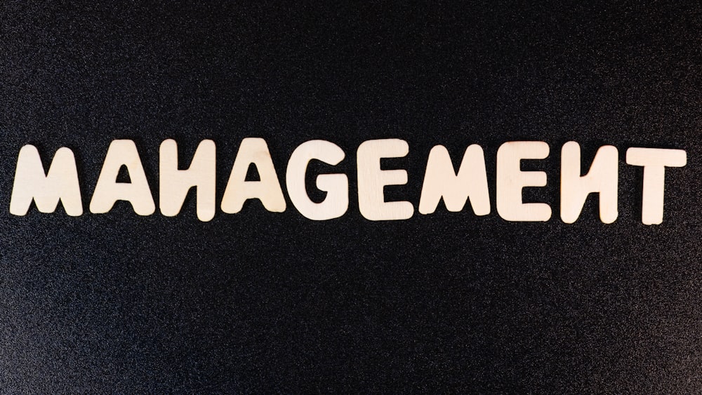 the word management written in white letters on a black background