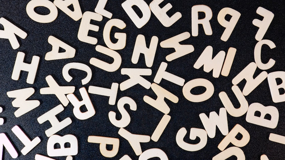 a close up of a black surface with white letters