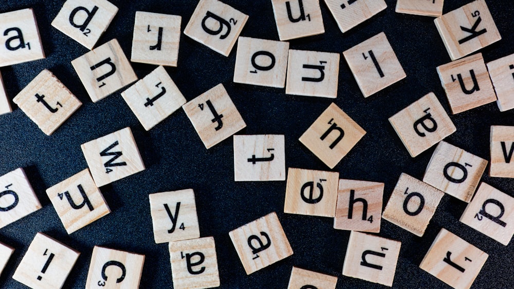 a pile of scrabble tiles spelling out words