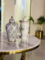 Close-up of a polished marble table with elegant gold and emerald decorative accents.