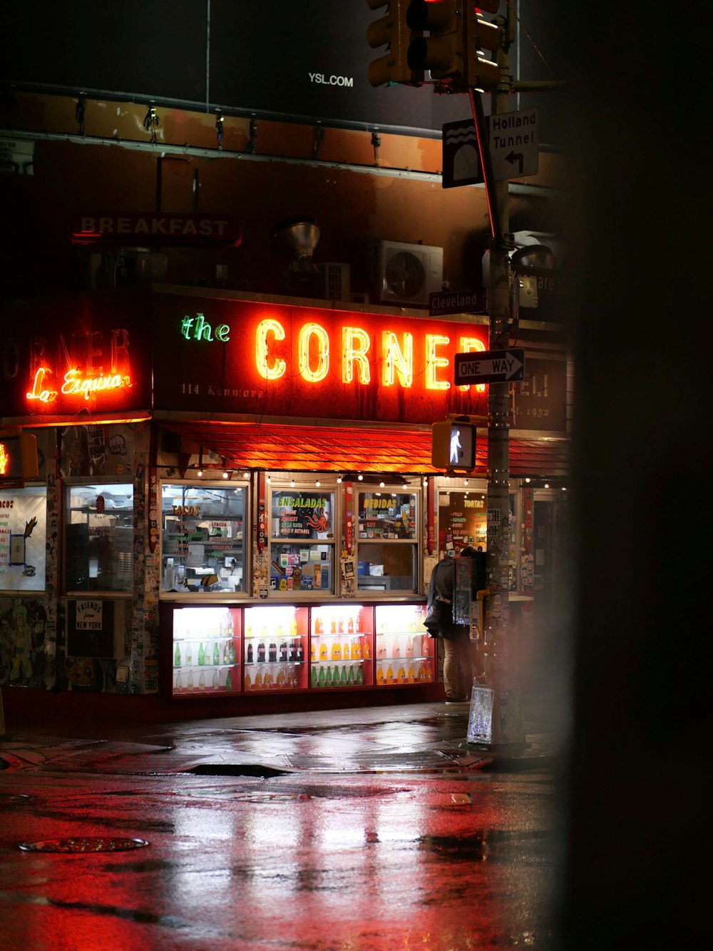 a corner store on a rainy night in the rain