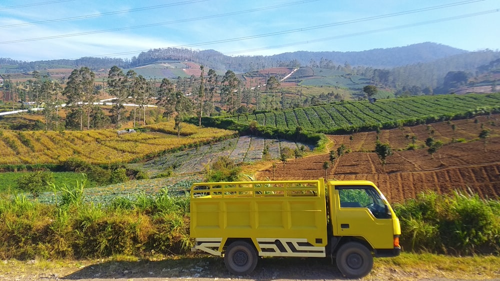 a yellow truck parked on the side of a road