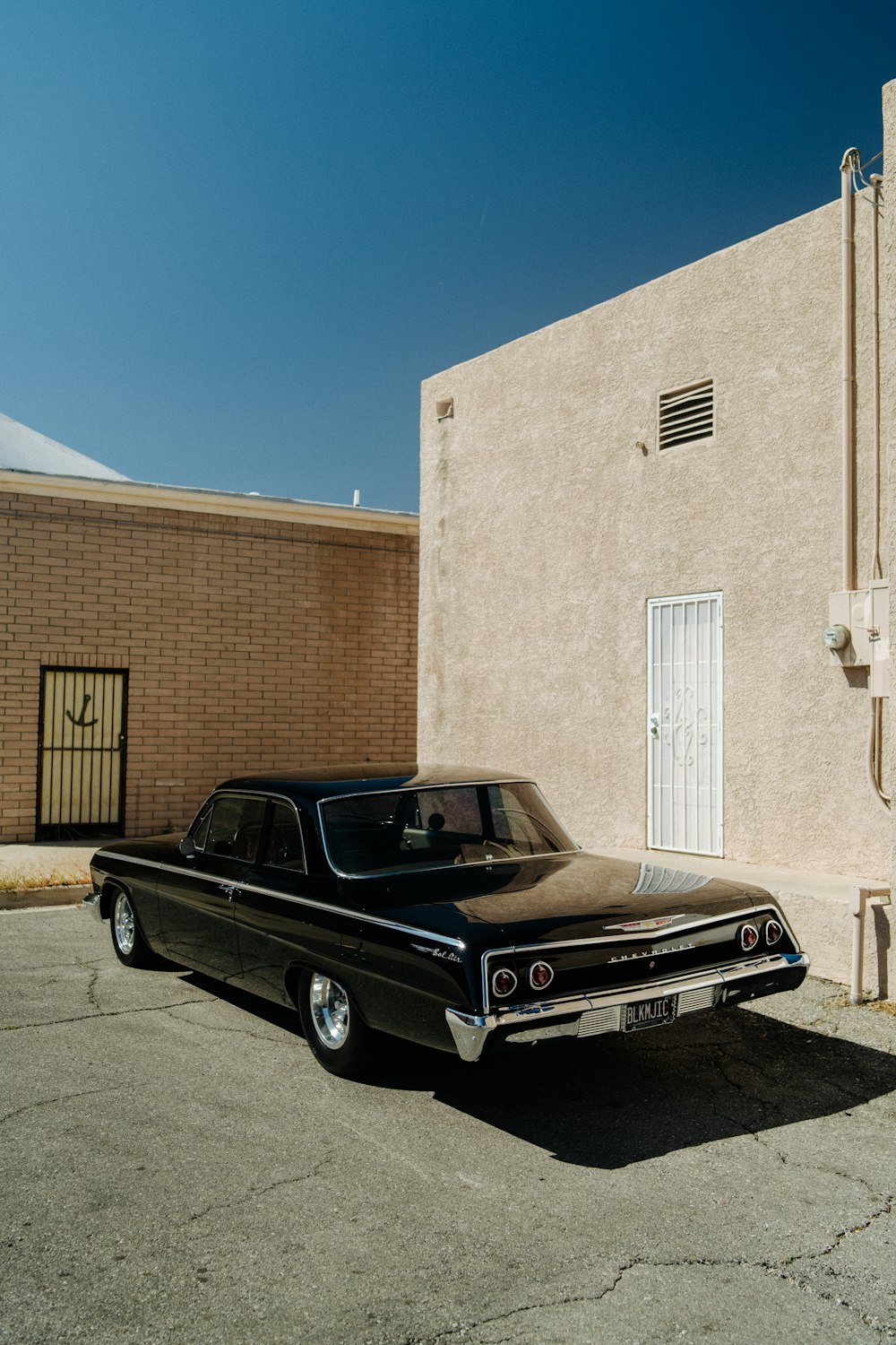 a black car parked in front of a building