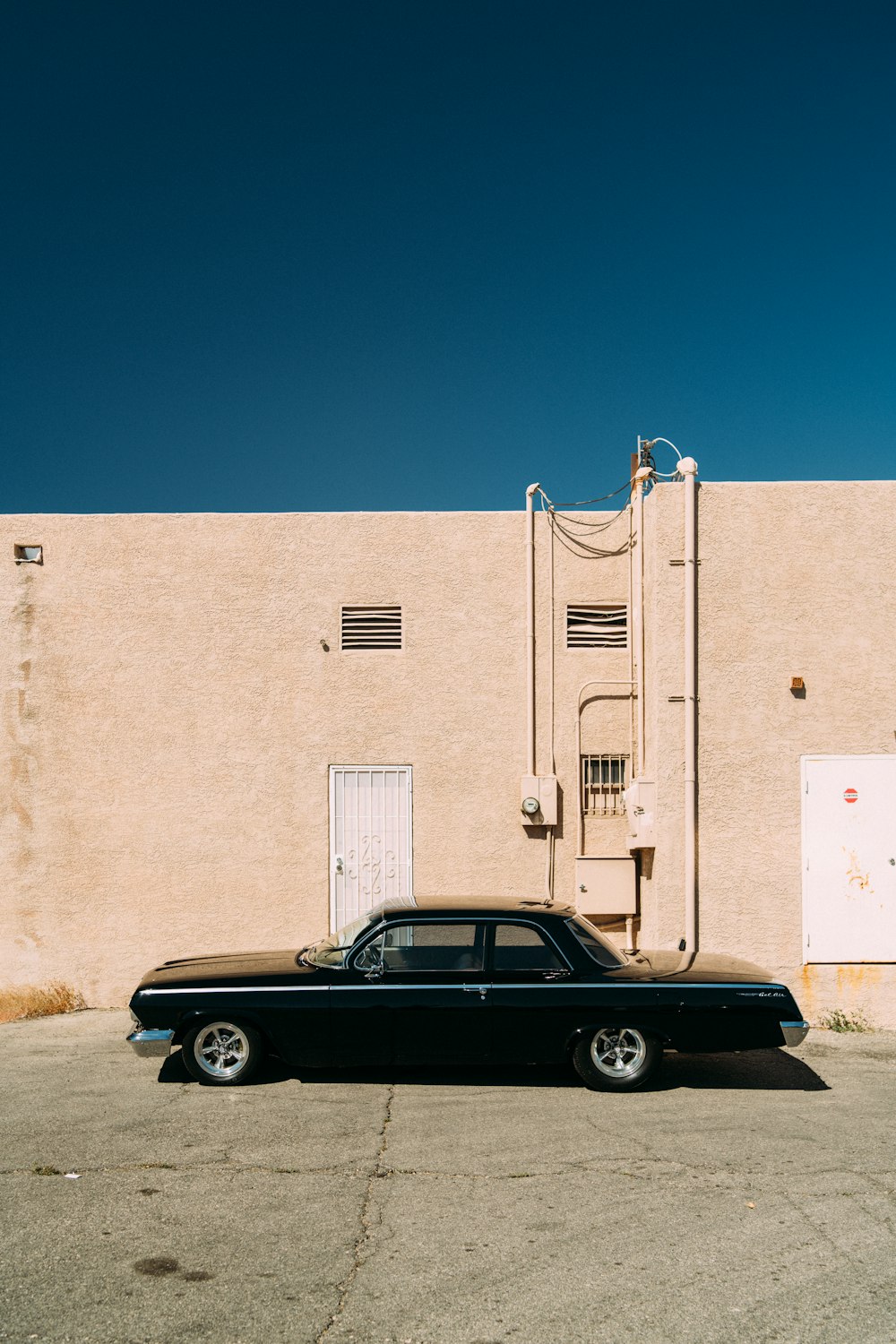 a black car parked in front of a building