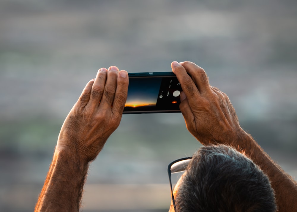 a man taking a picture with his cell phone