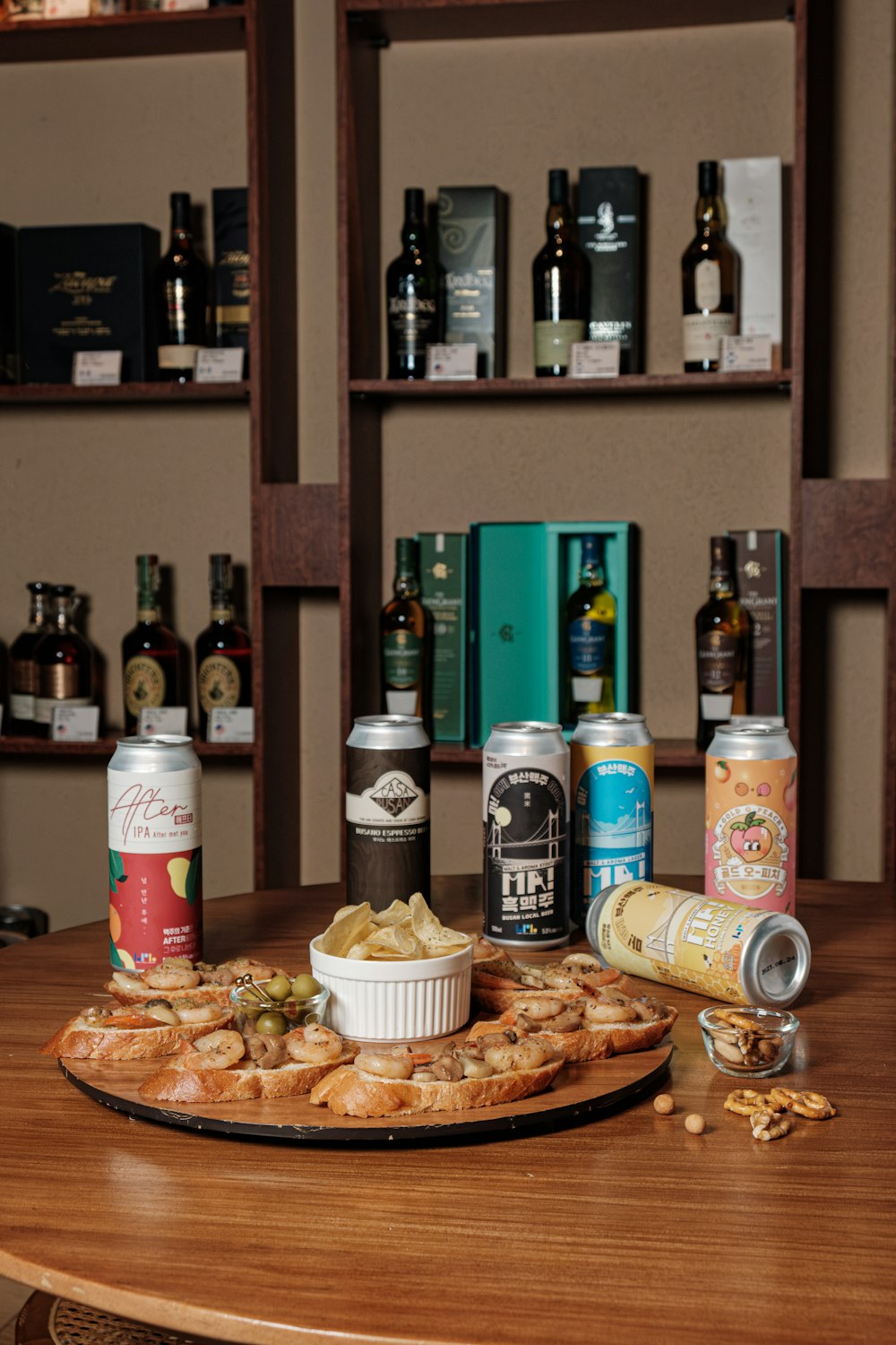 a wooden table topped with lots of food and drinks