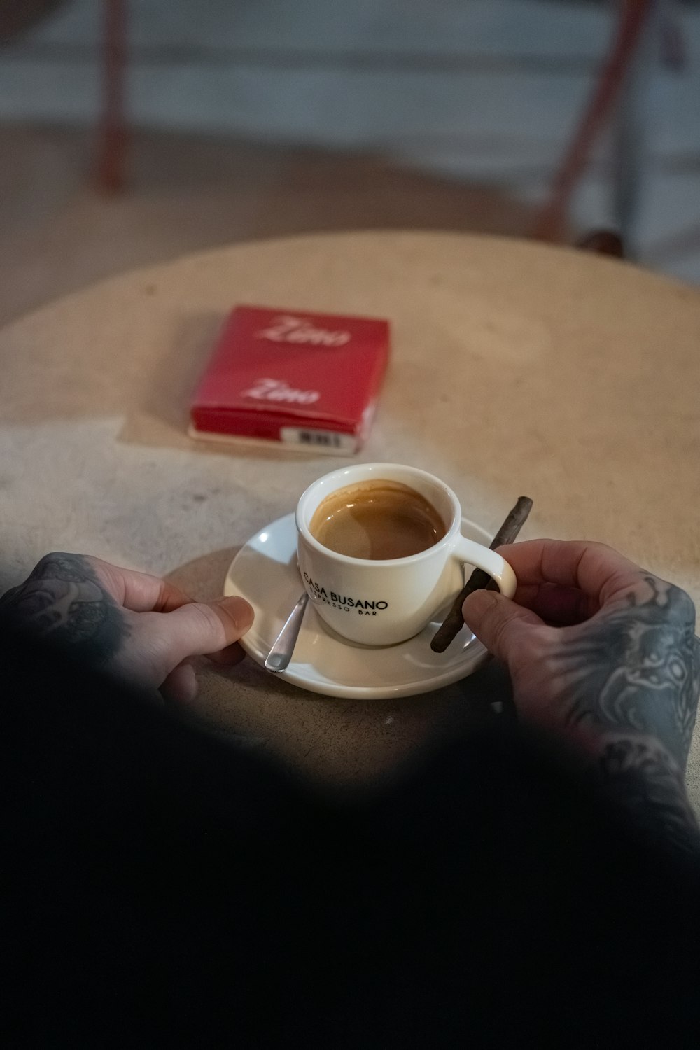 a person sitting at a table with a cup of coffee