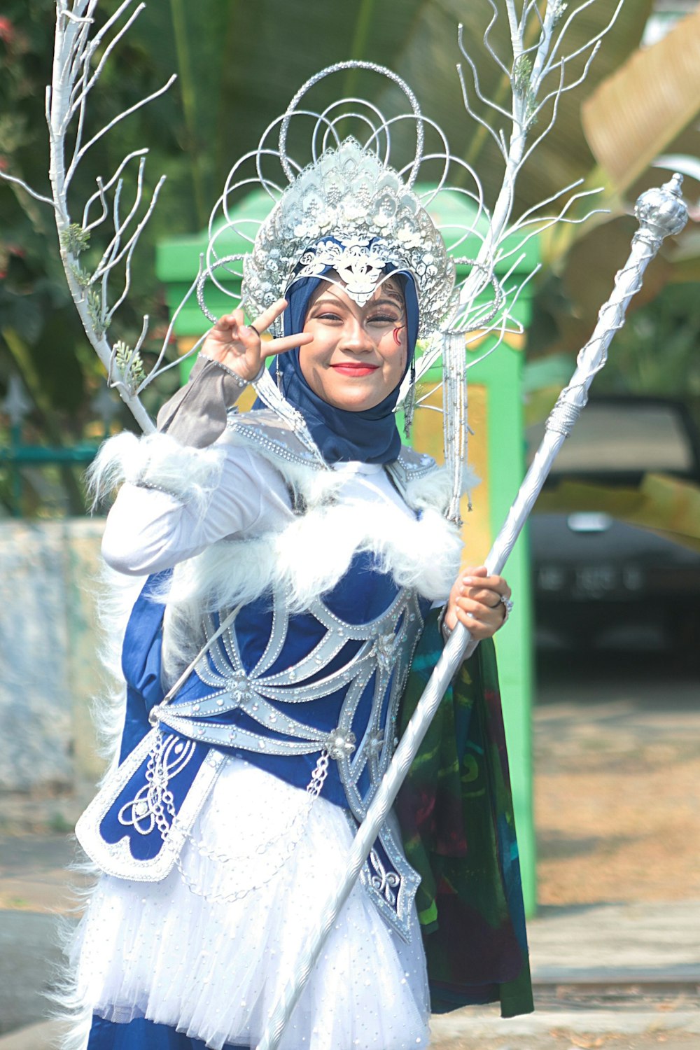 a woman in a costume holding a stick