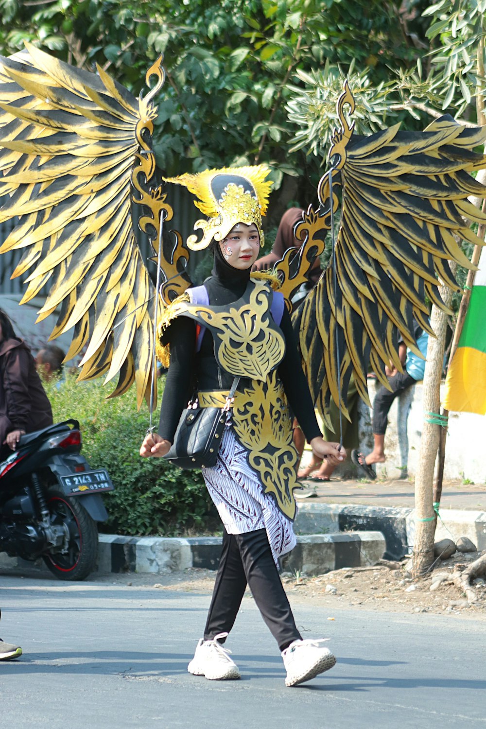 a person walking down a street with a large bird costume on