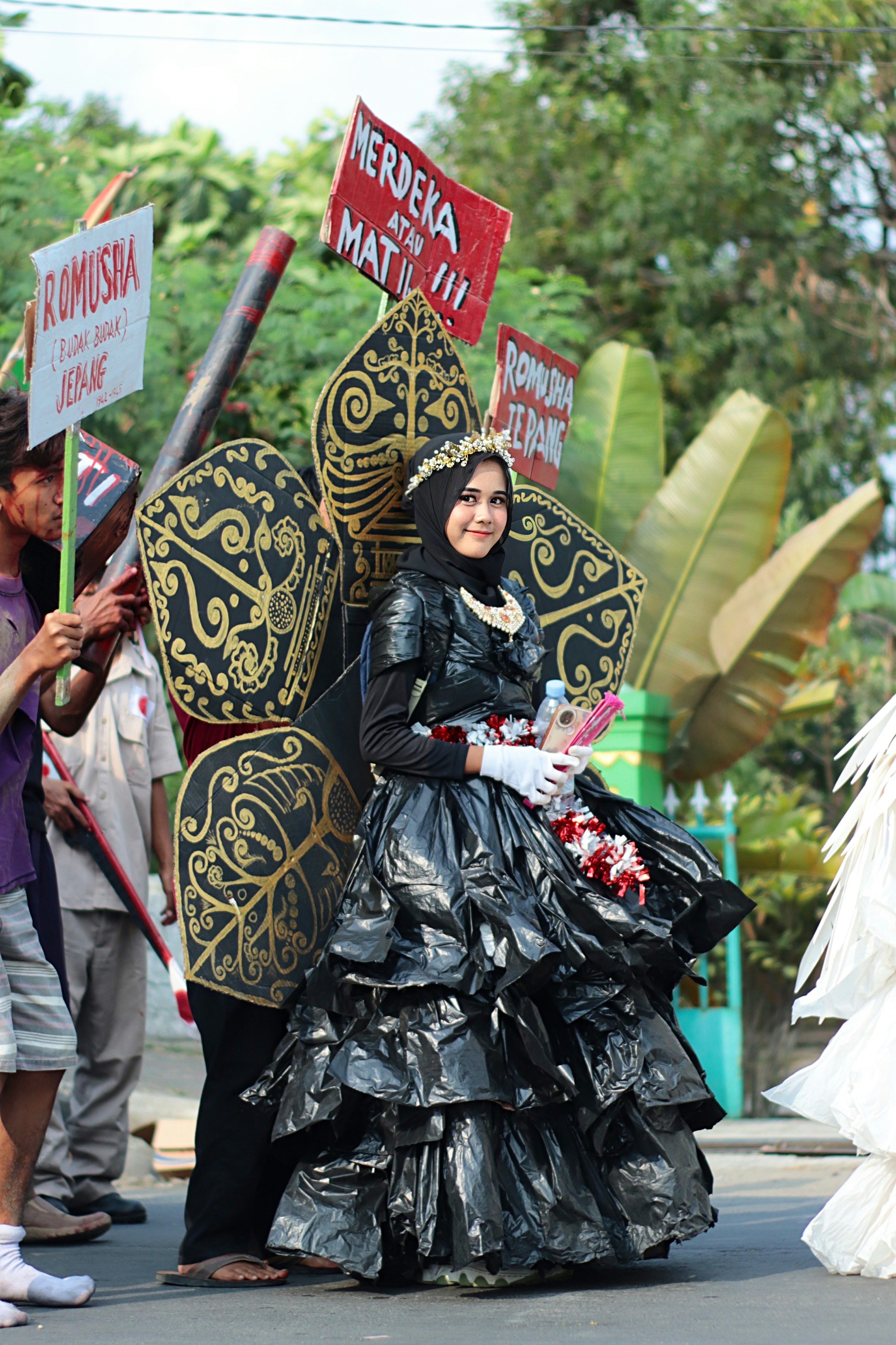 seorang wanita bergaun hitam memegang tanda