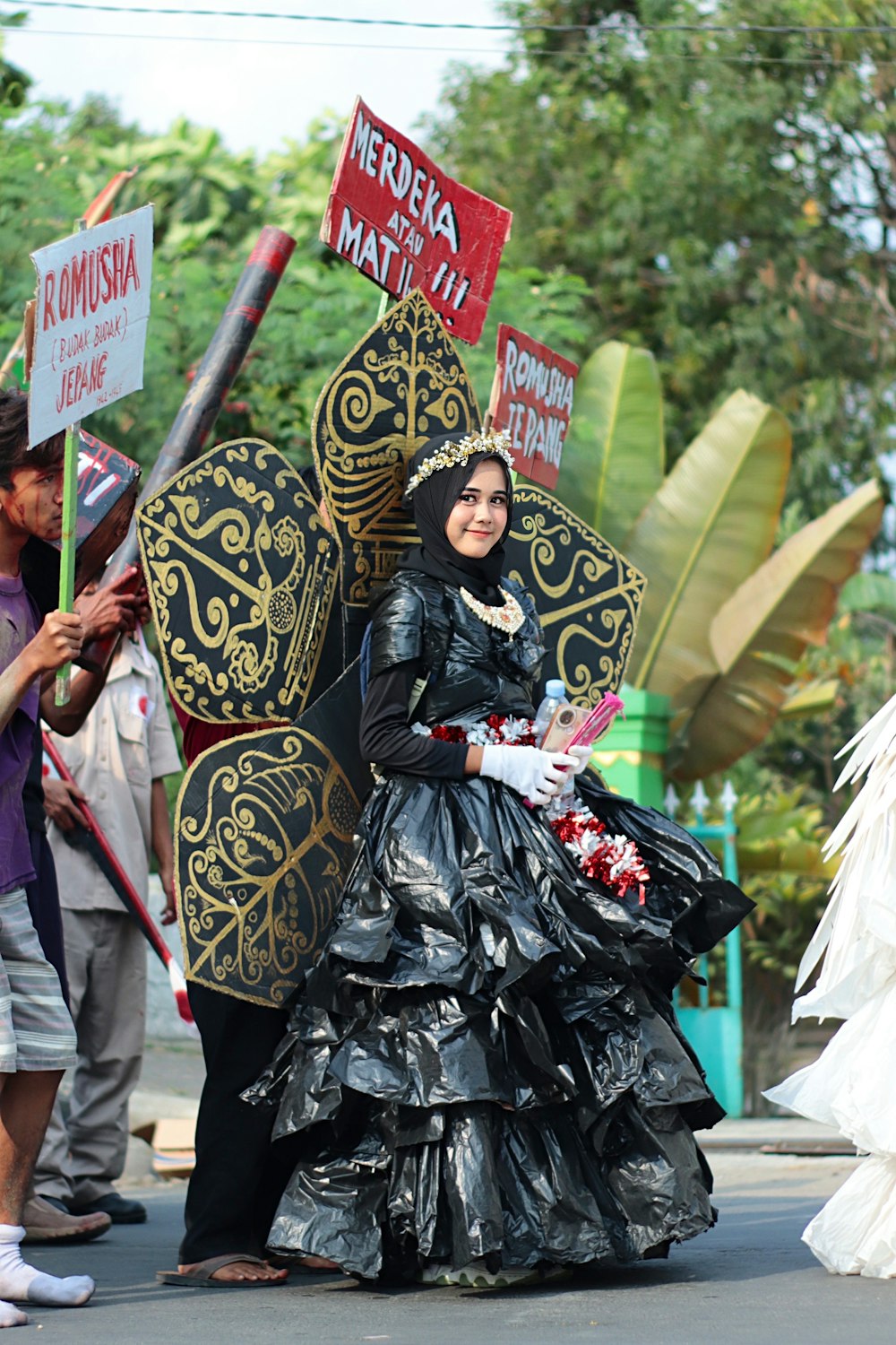 a woman in a black dress holding a sign