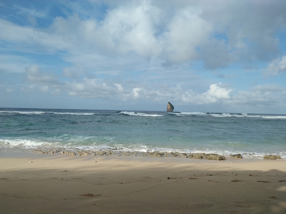 a person riding a surfboard on a wave in the ocean