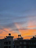 Sunset view over oil storage tanks with blue hues.