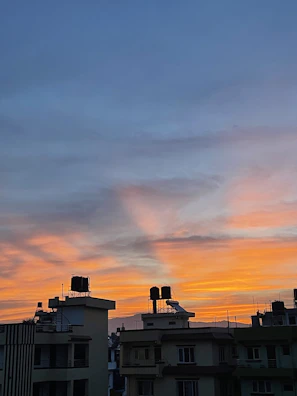 Sunset view over oil storage tanks with blue hues.