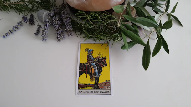 A vibrant illustration of the Knight of Wands tarot card, showing a fiery knight charging forward on a spirited horse, surrounded by swirling flames and dynamic energy.