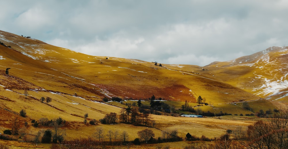 a scenic view of a mountain range with snow on the tops