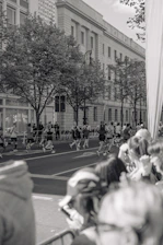 Runners in black and red gear training together on a city street at dawn