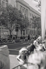 Runners in black and red gear training together on a city street at sunrise.