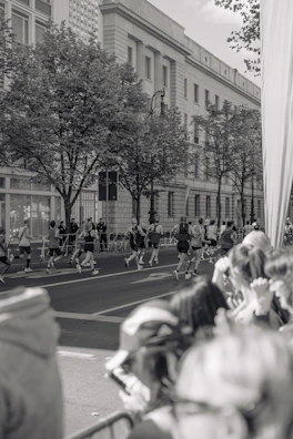 Group of runners warming up together on a city sidewalk