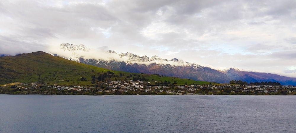 a body of water with mountains in the background