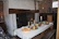 Rustic wooden dining table with natural edges set in a cozy kitchen.