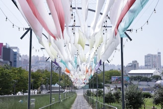 PVC strip curtains hanging in a busy industrial workspace, flexing as people pass through.