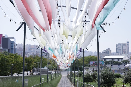 PVC strip curtains hanging in a busy industrial workspace, flexing as people pass through.