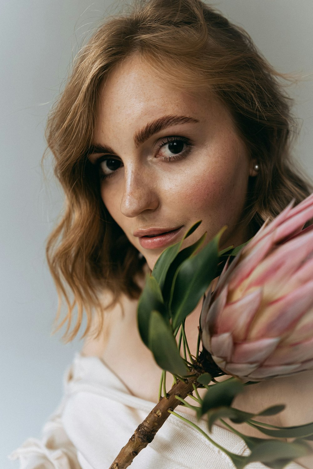 a woman with a flower in her hand