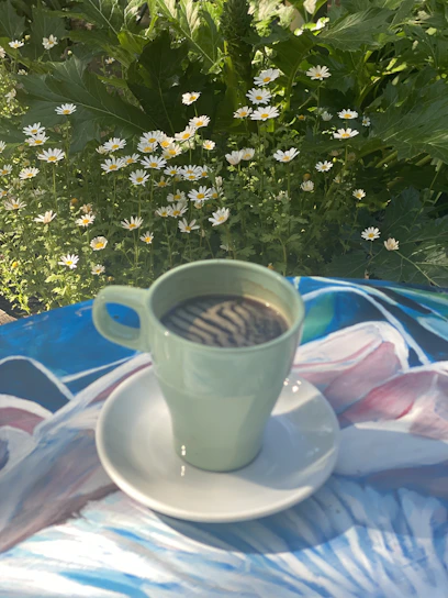 A vibrant coffee mug featuring a colorful, custom floral design glowing in morning light.