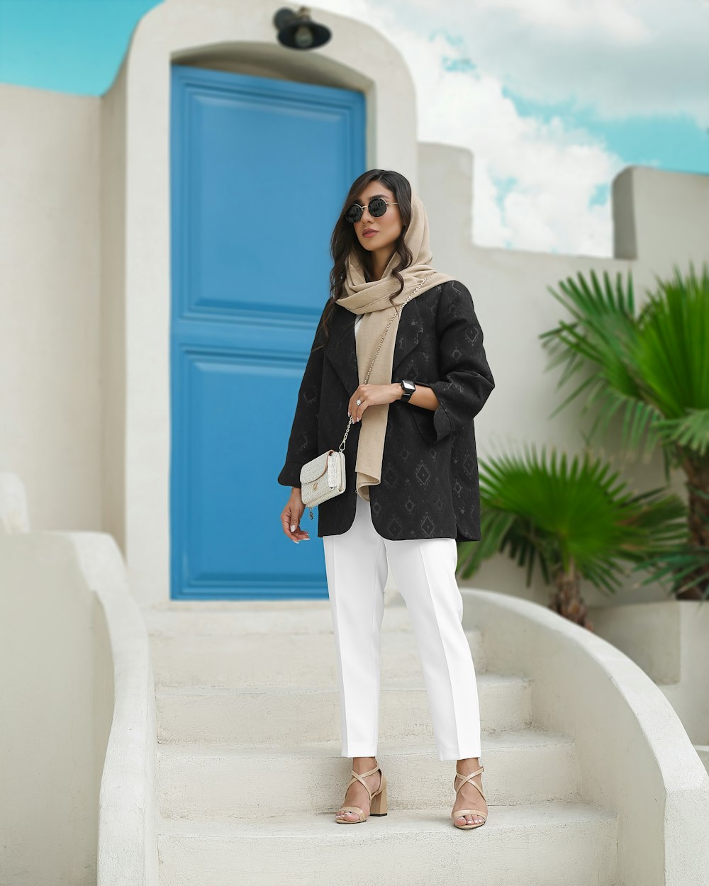 a woman standing on the steps of a house