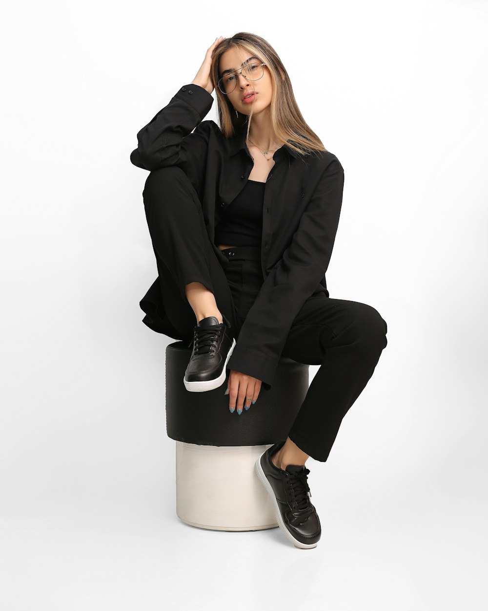 a woman sitting on top of a stool
