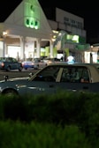 Night view of a Denizli Taksi car near the City Hospital entrance.
