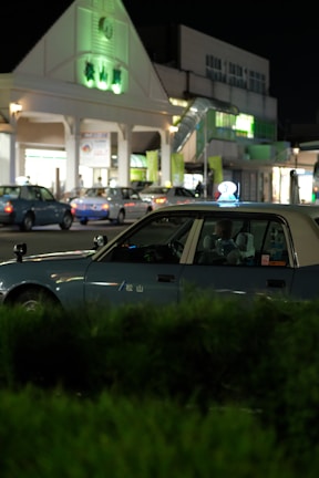 Night view of a Denizli Taksi car near the City Hospital entrance.