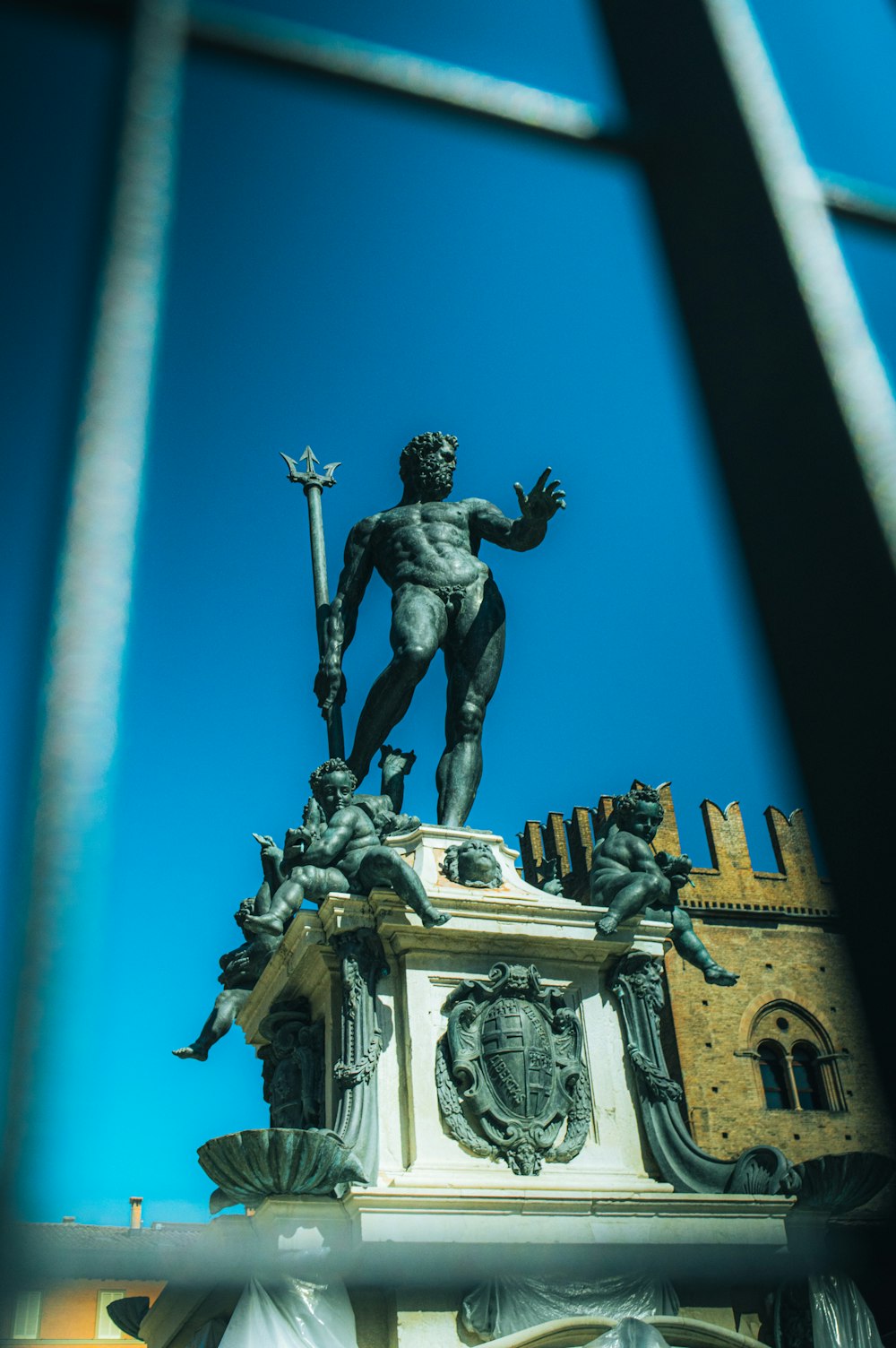 a statue of a man holding a sword on top of a building