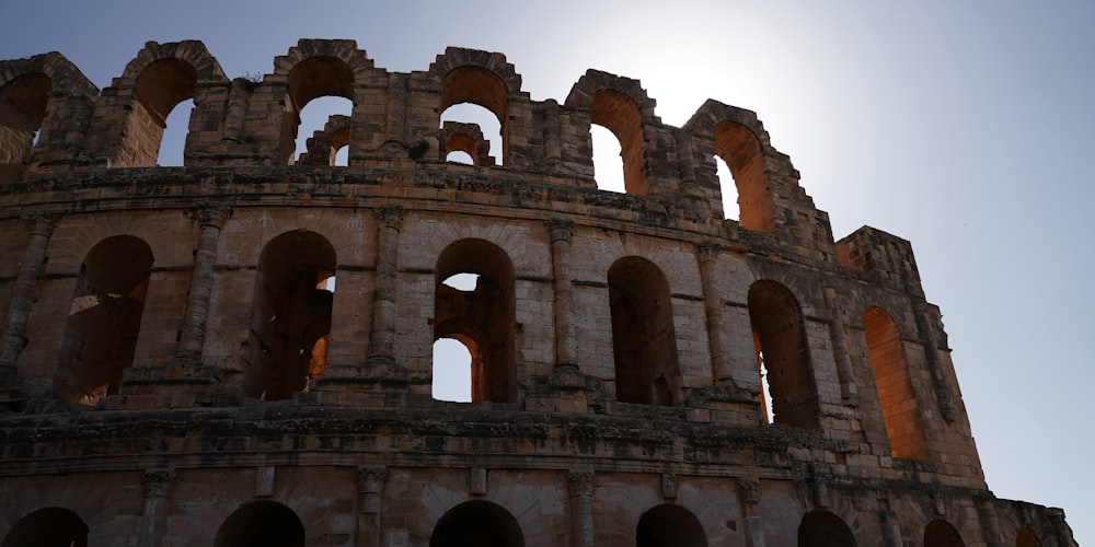 the sun shines through the windows of an old building