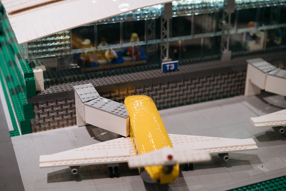 a lego model of a yellow and white plane