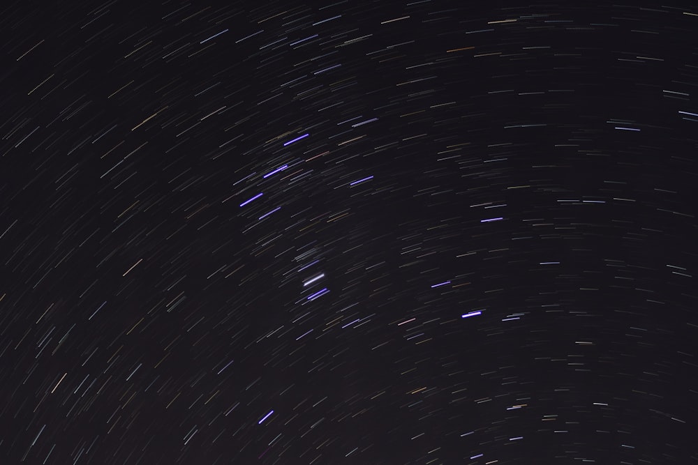 the night sky is filled with star trails