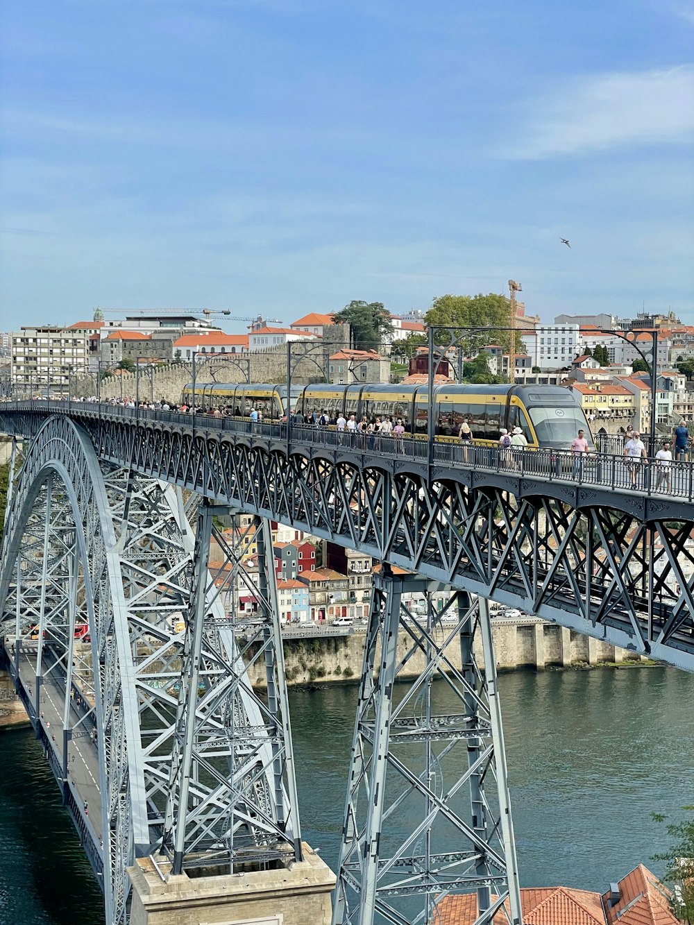 a train crossing a bridge over a body of water