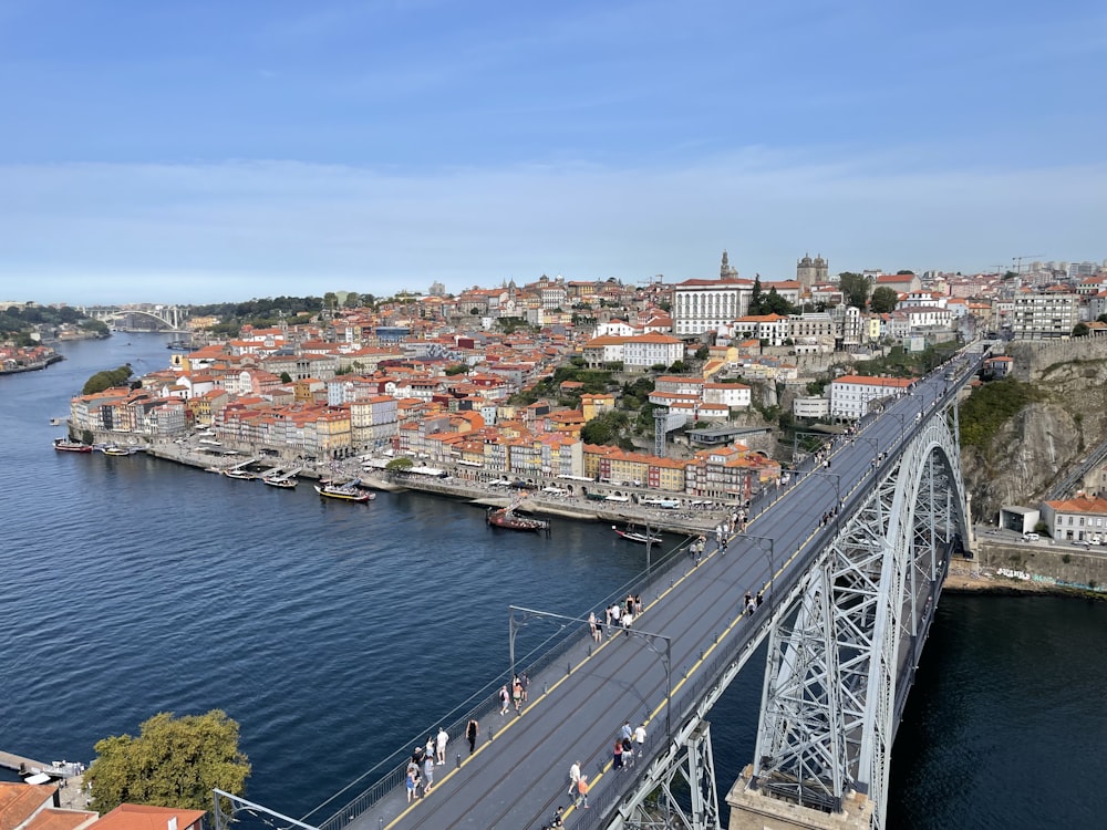 a bridge over a river with a city in the background