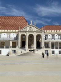 a large white building with a red roof