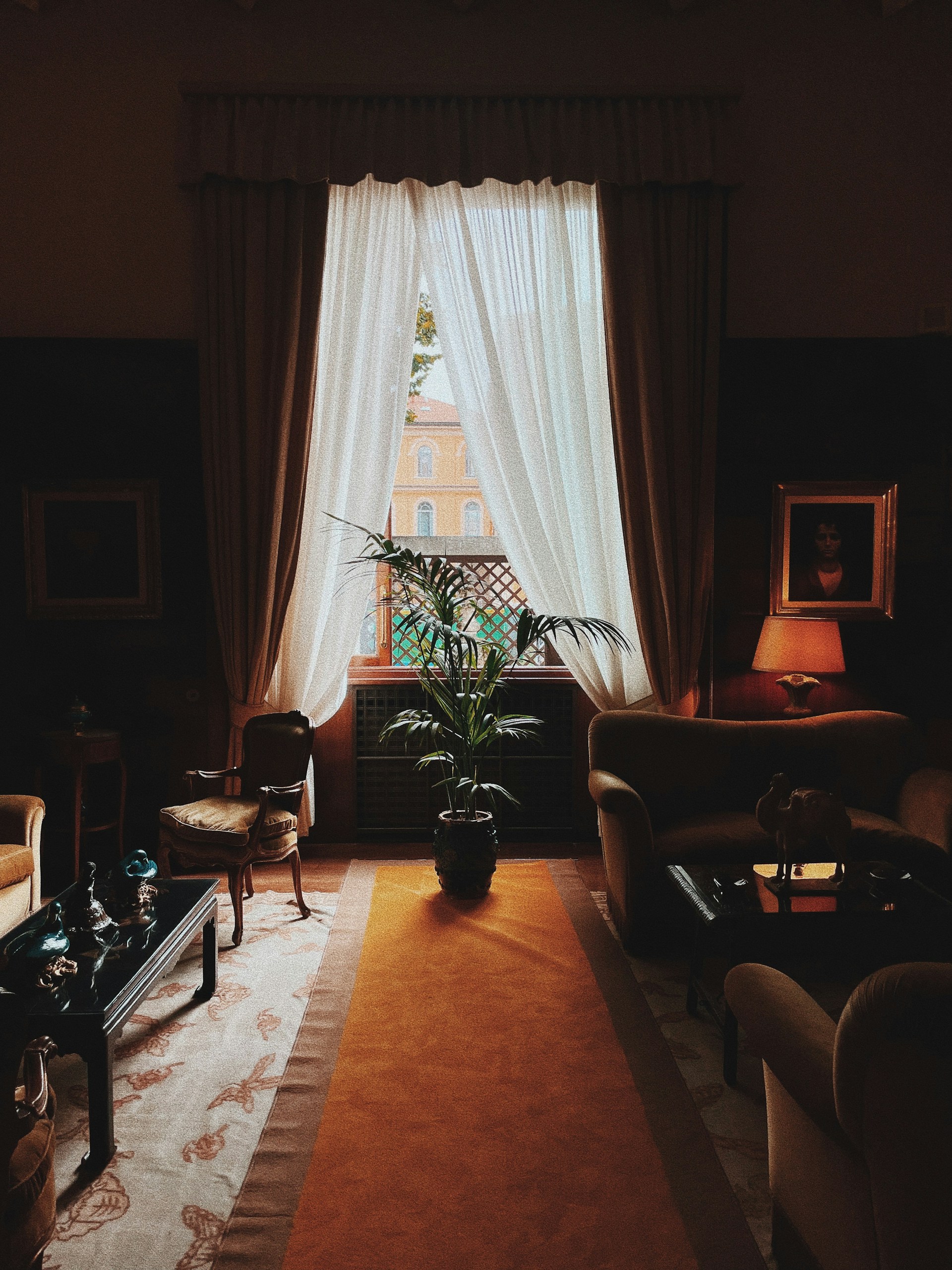 a living room filled with furniture and a large window