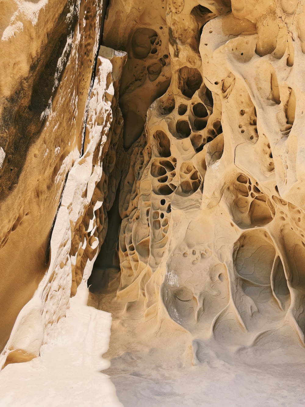 a large rock formation with snow on the ground