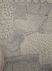 Complex abstract design comprised of various patterns including lines, dots, and curves. The intricacies form a textured patchwork with areas of dense dot clusters and flowing linear sections.