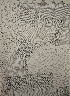 Complex abstract design comprised of various patterns including lines, dots, and curves. The intricacies form a textured patchwork with areas of dense dot clusters and flowing linear sections.