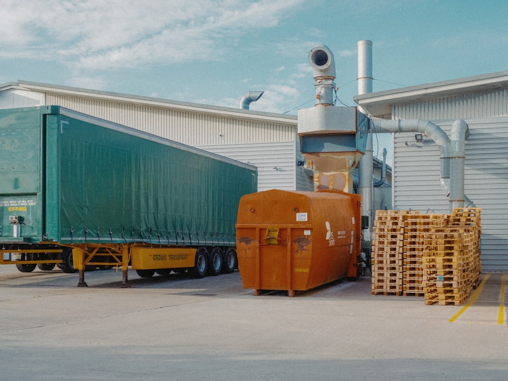 a semi truck is parked in front of a warehouse