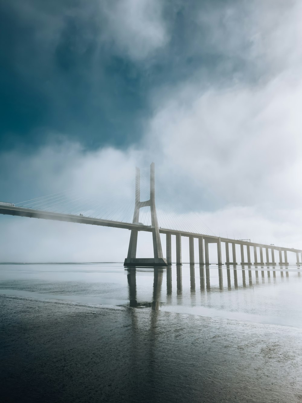 a long bridge is shown in the middle of the water