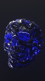 A close-up of translucent crystal skulls shimmering under museum lights, revealing delicate internal patterns.