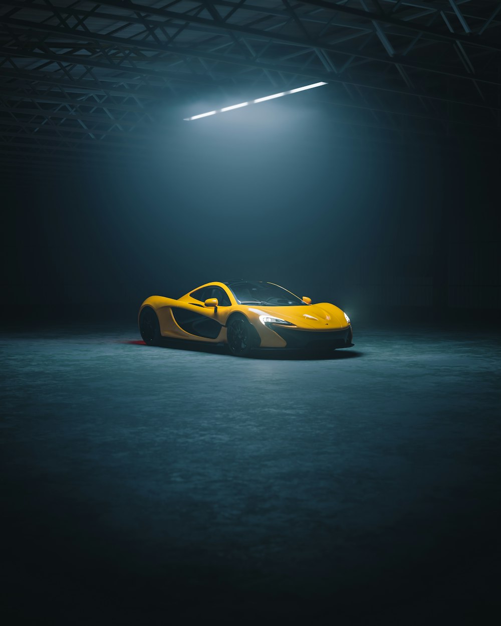 a yellow sports car parked in a dark garage